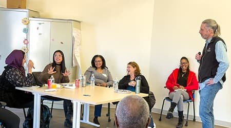 Family service providers talk around a table during a training workshop