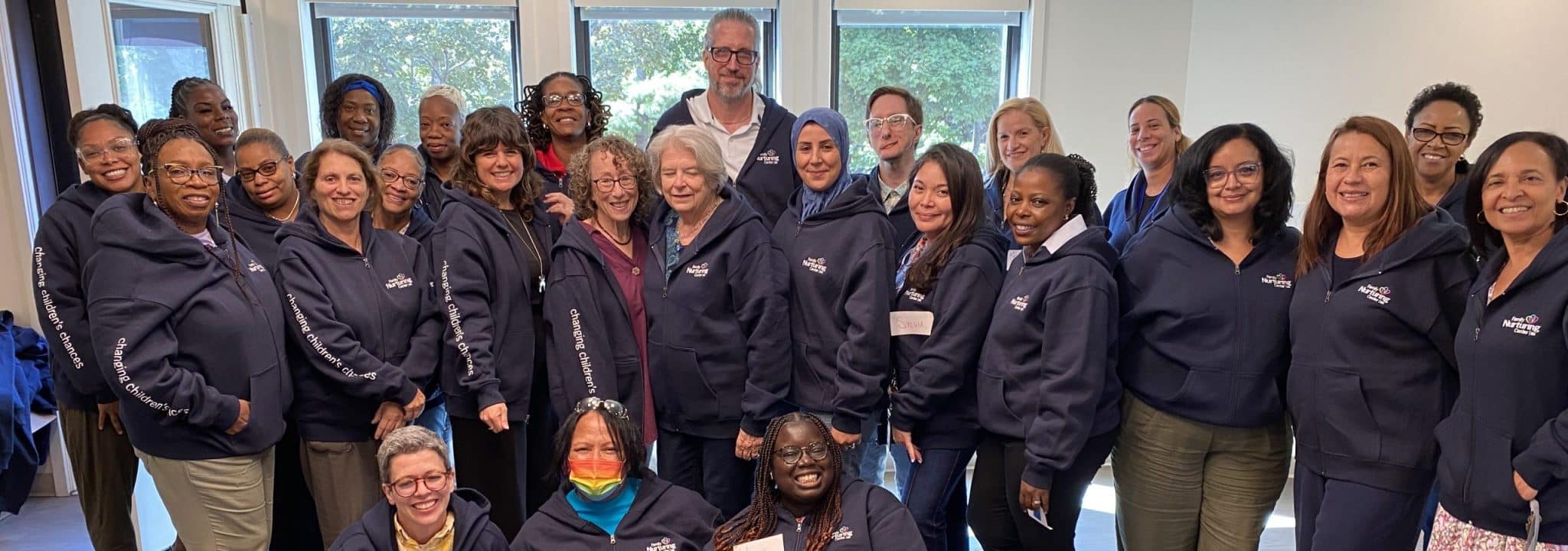 The FNC team gathers for a group photo in matching sweatshirts that read changing children’s chances.