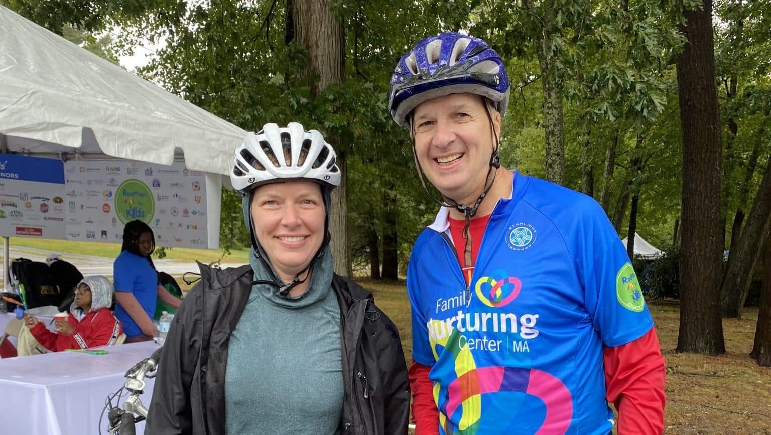 Two riders share a laugh near the event tents at the Rodman Ride for Kids