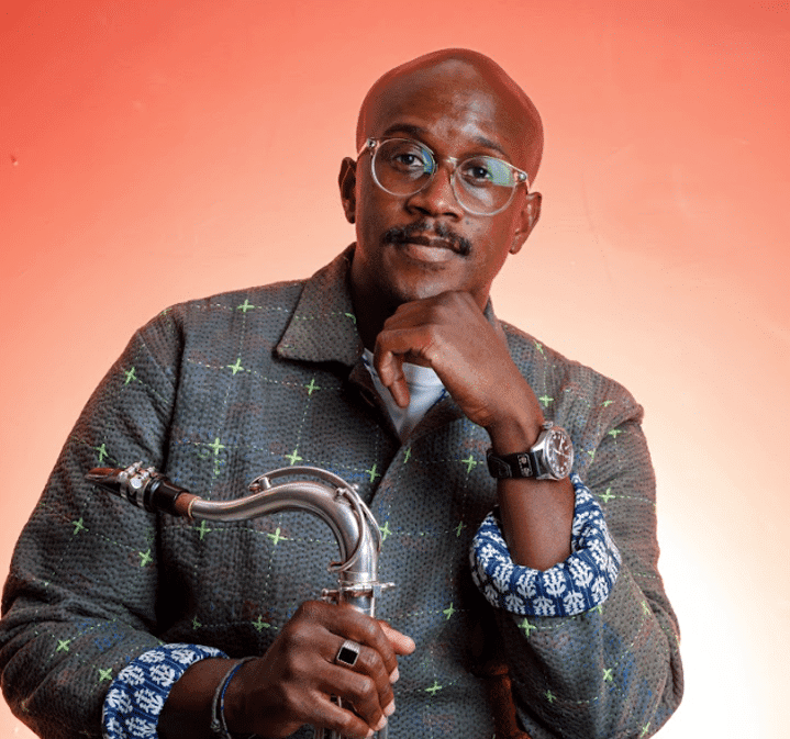 Gregory Groover Jr. holding his saxophone